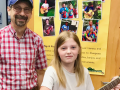 Teacher Fred Gebhardt presents Play it Forward! guitar to Kinley B!