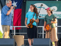Alan Tompkins presents Play it Forward! instruments to Hannah B and Sarah B at Wylie Jubilee 2024. ©Nate Dalzell