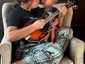 One of our Play it Forward! recipients practices while little brother looks on!