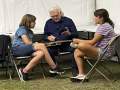 Ricky explains mandolin tuning at Bloomin\' 2023; Adelaide asks \"is he really famous?\" (Angie Logan)