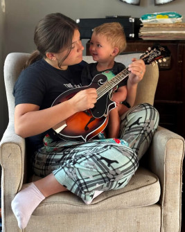 One of our Play it Forward! recipients practices while little brother looks on!
