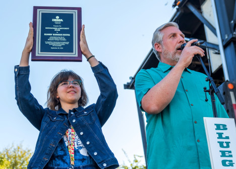 Jessica Tompkins displays the IBMA Distinguished Achievement Award at Bloomin Bluegrass 2024 (by Nate Dalzell)